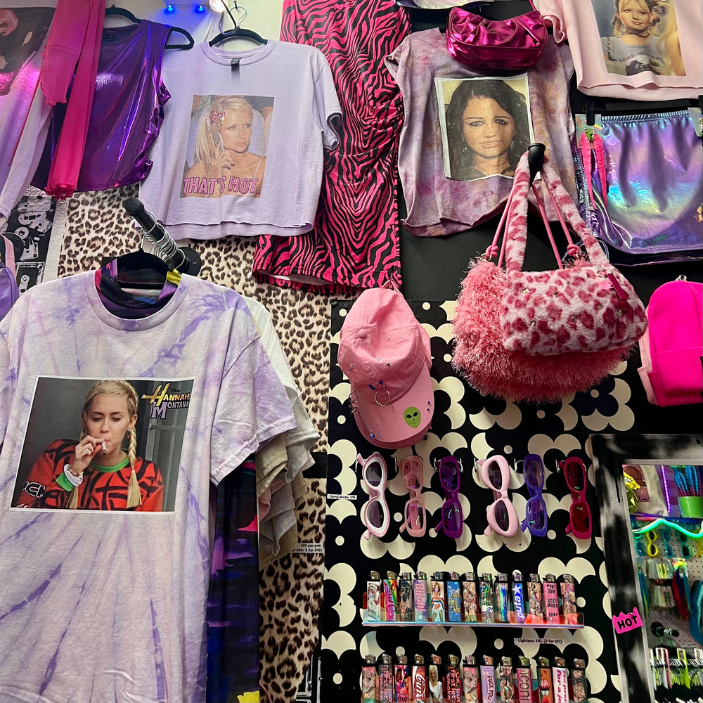 Printed tees, caps and accessories on the wall at Aliens of Brooklyn
