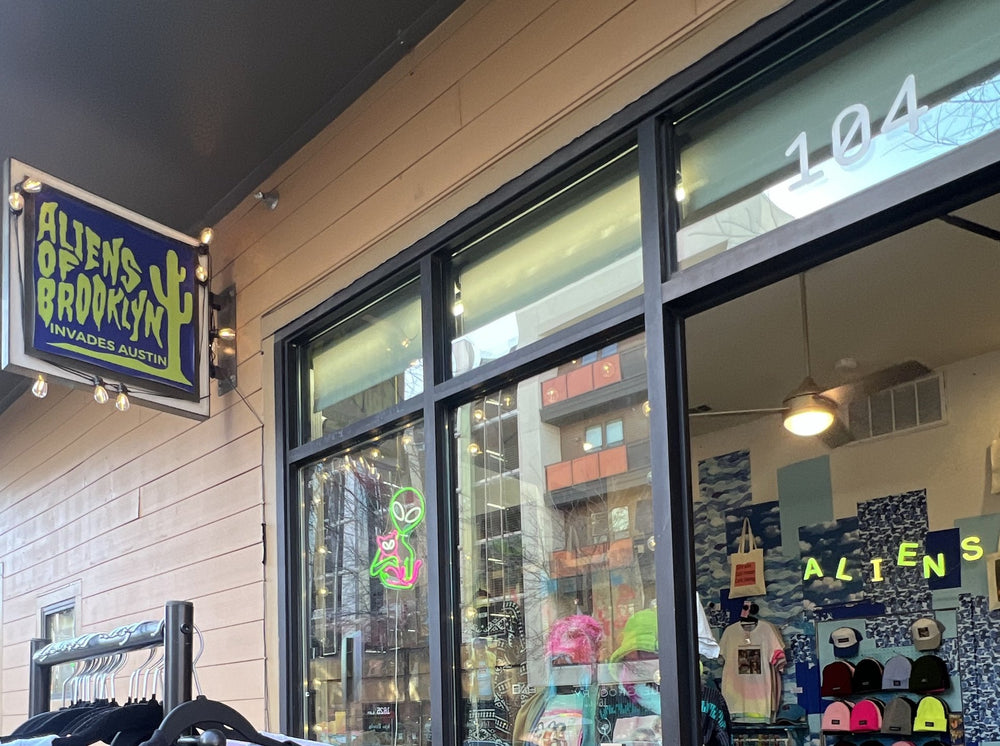 Storefront of Aliens of Brooklyn at 1630 E 6th St #104, East Austin, with the Aliens of Brooklyn Invades Austin sign